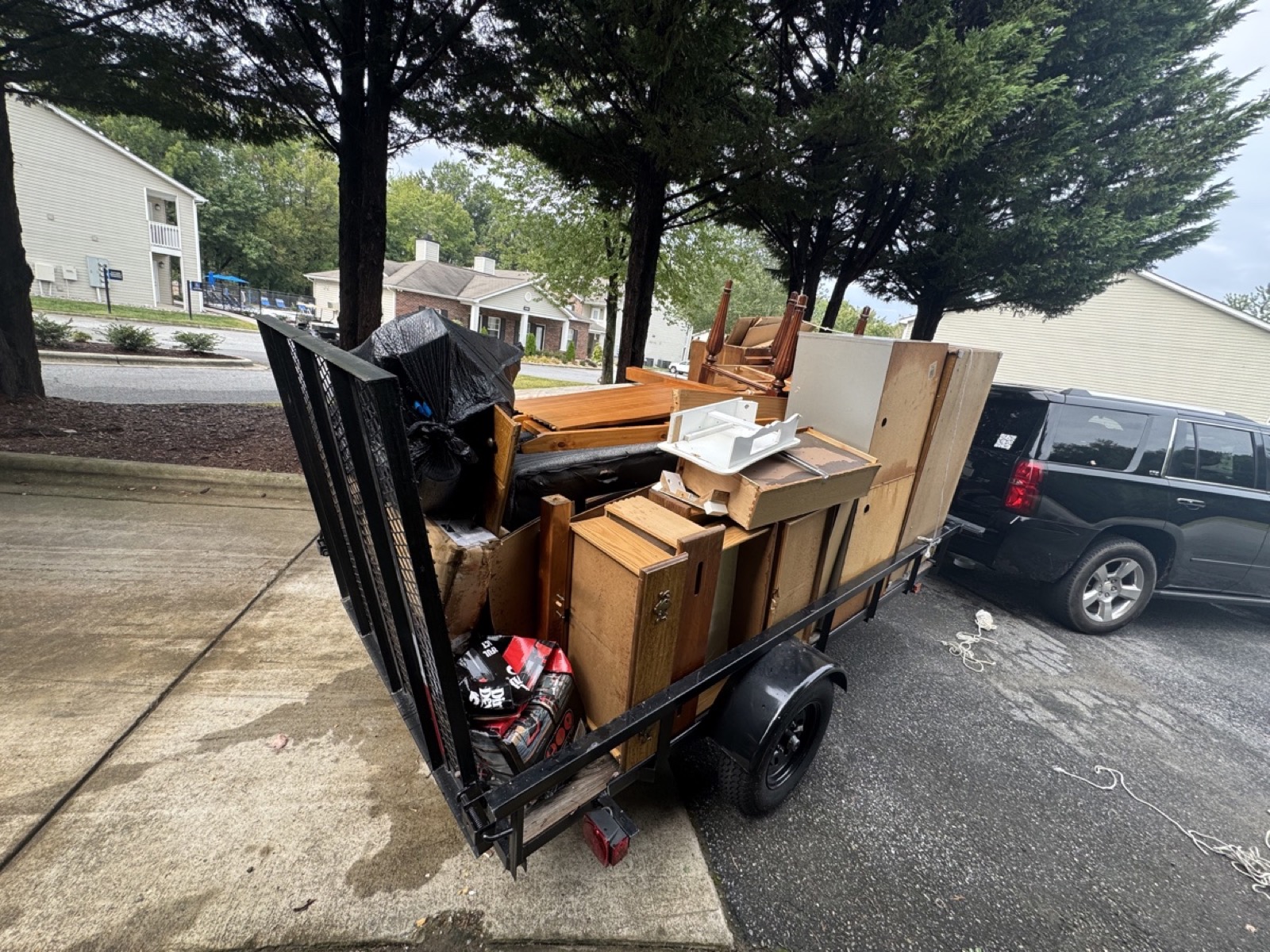 Junk removal crew loading unwanted furniture in Greensboro NC